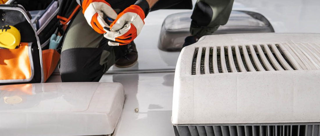 RV furnace repair technician servicing LP gas heating unit in Stuart Florida